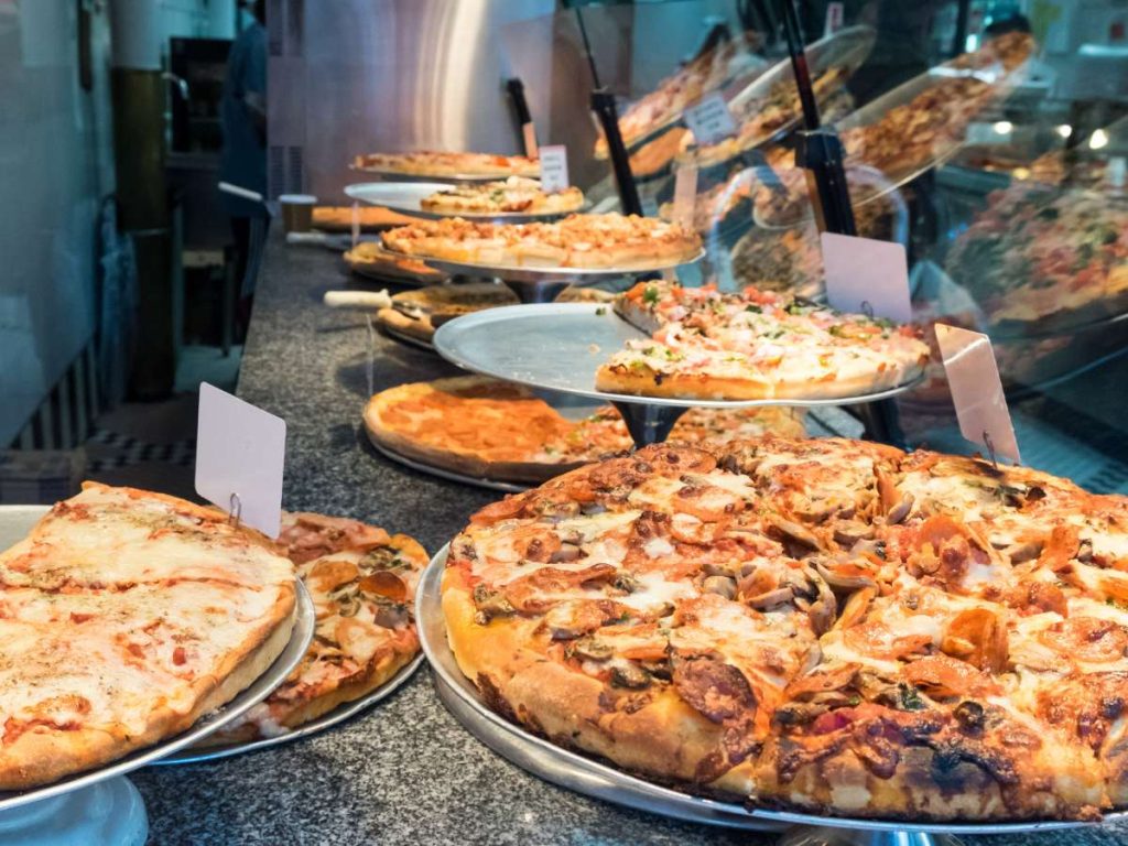 A selection of pizza styles available at a pizzeria.