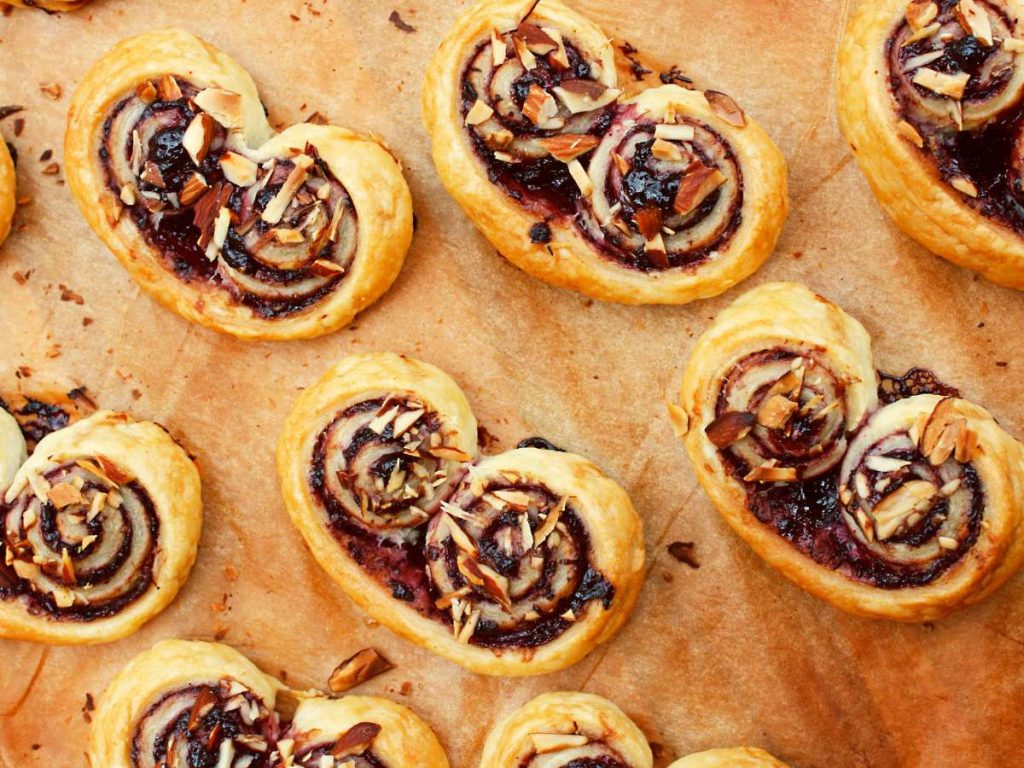A batch of pinwheels on a cutting board with various fillings.